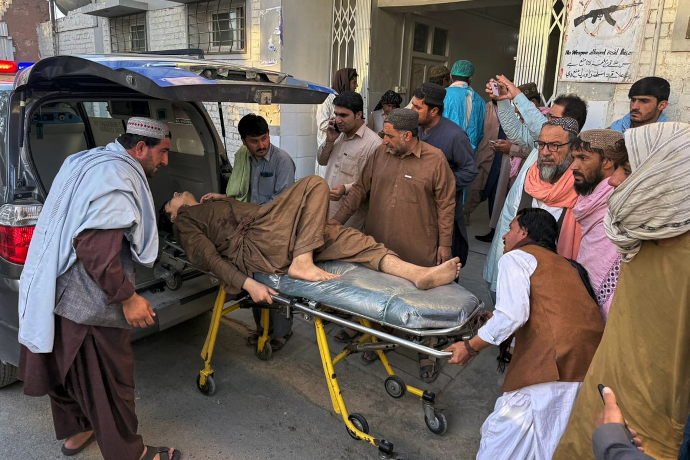 People bring a man who was injured in the clashes between Pakistani and Afghan forces in the border area for medical treatment at a hospital in Chaman, Pakistan, on Wednesday.